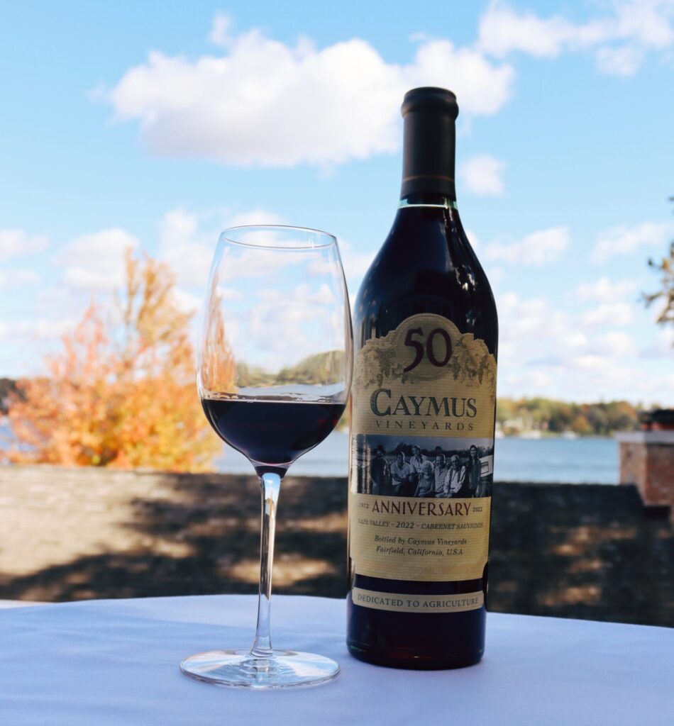 A bottle and glass of Caymus wine